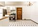 Cozy kitchen with white cabinets, black and white checkered floors, and stainless steel appliances at 8004 Minlo Dr, Indianapolis, IN 46227