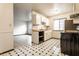 Kitchen with white cabinets, checkered floors, newer appliances, and bright natural light at 8004 Minlo Dr, Indianapolis, IN 46227