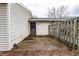 View of the fenced-in patio area with door to the house and vinyl siding at 8004 Minlo Dr, Indianapolis, IN 46227