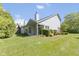 Well-maintained backyard shows the home's exterior, landscaping, and outdoor living space at 8212 Nekton Ln, Indianapolis, IN 46236