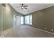 Spacious bedroom featuring a ceiling fan, large windows, neutral carpet and walls at 8212 Nekton Ln, Indianapolis, IN 46236