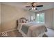 Cozy bedroom with a comfortable bed, complemented by a ceiling fan and natural light at 8212 Nekton Ln, Indianapolis, IN 46236