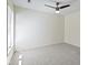 This large bedroom includes neutral walls and carpet plus a bright window at 8212 Nekton Ln, Indianapolis, IN 46236