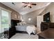Cozy bedroom with ceiling fan, neutral carpet, and plenty of natural light at 8212 Nekton Ln, Indianapolis, IN 46236