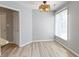 Bright dining room with natural light, new flooring and modern light fixture at 8212 Nekton Ln, Indianapolis, IN 46236
