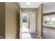Inviting entryway boasts neutral walls, modern flooring, and a storm door leading to the outdoors at 8212 Nekton Ln, Indianapolis, IN 46236