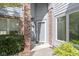 A front door entrance surrounded by brick and shrubbery at 8212 Nekton Ln, Indianapolis, IN 46236
