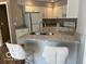 Well-lit kitchen with island seating, stainless steel appliances and white cabinets at 8212 Nekton Ln, Indianapolis, IN 46236