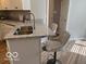 Open kitchen featuring a granite countertop island with seating and stainless steel faucet at 8212 Nekton Ln, Indianapolis, IN 46236