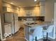 Bright kitchen with stainless steel appliances, granite countertops, and white cabinetry at 8212 Nekton Ln, Indianapolis, IN 46236