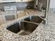Close up of the kitchen sink, faucet, and granite countertops at 8212 Nekton Ln, Indianapolis, IN 46236