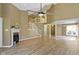 Two-story living room with hardwood floors, a fireplace, an open staircase and lots of natural light at 8212 Nekton Ln, Indianapolis, IN 46236