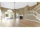 Open living room featuring a fireplace, hardwood floors, a ceiling fan and access to the backyard at 8212 Nekton Ln, Indianapolis, IN 46236