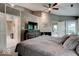 Primary bedroom with dark furniture, ceiling fan, and ensuite access at 8212 Nekton Ln, Indianapolis, IN 46236