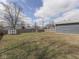 Large backyard with lush green lawn, shed, and playground at 912 Sweetbriar Ave, Whiteland, IN 46184