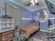 Cozy bedroom with hardwood flooring, a ceiling fan, and ample storage at 912 Sweetbriar Ave, Whiteland, IN 46184