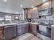 The kitchen has dark cabinets, stainless appliances, and an eye-catching backsplash at 912 Sweetbriar Ave, Whiteland, IN 46184