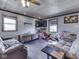 Relaxing living room boasts wood ceiling, neutral paint, lots of natural light, and hardwood floors at 912 Sweetbriar Ave, Whiteland, IN 46184