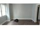A minimalist bedroom with light gray walls, hardwood floors, and a bright window at 951 N Tuxedo St, Indianapolis, IN 46201
