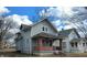 Charming two-story home with a classic design, featuring a covered front porch with brick pillars at 951 N Tuxedo St, Indianapolis, IN 46201