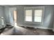 A bright living room featuring hardwood floors and a large window for ample natural light at 951 N Tuxedo St, Indianapolis, IN 46201