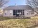 Back exterior showcasing a screened porch, stone accents, and a well-maintained yard, perfect for outdoor living at 9978 Niagara Dr, Fishers, IN 46037