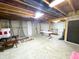 Unfinished basement with exposed beams, concrete floor, and work tables provides versatile space at 9978 Niagara Dr, Fishers, IN 46037