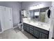 Neutral bathroom featuring a double vanity sink, large mirror, and separate toilet area at 9978 Niagara Dr, Fishers, IN 46037