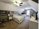 This spacious bedroom with vaulted ceilings includes a double bed, desk area, and television at 9978 Niagara Dr, Fishers, IN 46037