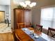 Traditional dining room with wood table, chairs, window and unique hutch-style cabinet at 9978 Niagara Dr, Fishers, IN 46037