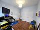 Bright exercise room features wood floors, television, and includes a treadmill with workout accessories at 9978 Niagara Dr, Fishers, IN 46037