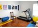 Bright exercise room features wood floors, inspirational art and includes a treadmill with workout accessories at 9978 Niagara Dr, Fishers, IN 46037