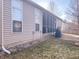Back exterior showcasing a screened porch, patio, and a well-maintained yard, perfect for outdoor living at 9978 Niagara Dr, Fishers, IN 46037
