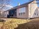 Back exterior showcasing a screened porch, stone accents, and a well-maintained yard, perfect for outdoor living at 9978 Niagara Dr, Fishers, IN 46037