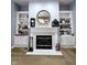 Cozy fireplace with built-in bookshelves, decor, and neutral walls creating a warm atmosphere at 9978 Niagara Dr, Fishers, IN 46037