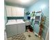 Well-lit laundry room with ample storage, washer and dryer, and a convenient utility sink at 9978 Niagara Dr, Fishers, IN 46037