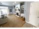 Spacious living room featuring neutral walls, carpet, fireplace, and built-in bookshelves at 9978 Niagara Dr, Fishers, IN 46037