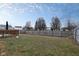 The fenced backyard offers green space for recreation with a deck in the corner at 10154 Holly Berry Cir, Fishers, IN 46038