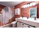Stylish bathroom featuring a double vanity, modern fixtures, and unique shower curtain at 10154 Holly Berry Cir, Fishers, IN 46038