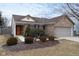 Charming single-story brick home featuring a well-manicured lawn and attached two-car garage at 10154 Holly Berry Cir, Fishers, IN 46038