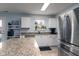 Bright kitchen with an island, granite countertops, and stainless steel appliances at 10154 Holly Berry Cir, Fishers, IN 46038