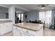 Stylish kitchen island with granite countertops, white cabinetry, and an open view to the dining area at 10154 Holly Berry Cir, Fishers, IN 46038