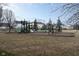 Community playground with swings, climbing structures and benches surrounded by bare trees at 10154 Holly Berry Cir, Fishers, IN 46038