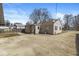 Backyard view showcasing the home's layout, siding, and spacious concrete area at 103 S Delawanda Ave, Muncie, IN 47303