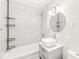 Clean bathroom features a vessel sink, chrome fixtures, and white subway tile shower and tub at 103 S Delawanda Ave, Muncie, IN 47303