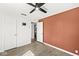 Bedroom features a ceiling fan, wood-look floors, and an open doorway to a bathroom at 103 S Delawanda Ave, Muncie, IN 47303