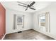 Cozy bedroom with two windows, wood-look floors, and neutral decor at 103 S Delawanda Ave, Muncie, IN 47303
