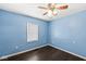 Cozy bedroom with a ceiling fan and natural light from a window, creating a relaxing retreat at 103 S Delawanda Ave, Muncie, IN 47303
