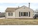 Charming home featuring beige siding, black shutters, and a well-maintained front yard at 103 S Delawanda Ave, Muncie, IN 47303
