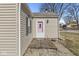 Home exterior featuring a cute pink door, siding, and small porch with stone detailing at 103 S Delawanda Ave, Muncie, IN 47303